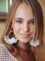 With her bright blue eyes sparkling like two precious gems and pearly white smile, Rachel looks exquisite in a white fishnet top and matching panties 